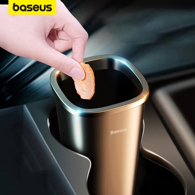 Hand dropping snack into Baseus car trash bin placed in car cupholder for easy waste disposal