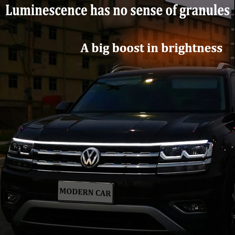 Flexible LED hood strip glowing white along vehicle front edge