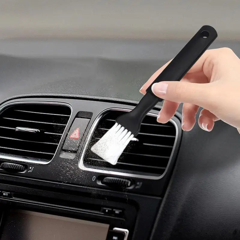 Air vent brush in action cleaning car AC slats – flexible and scratch-free