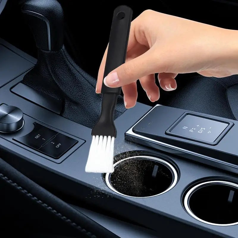 Detailing brush used on car dashboard controls, knobs, and vents