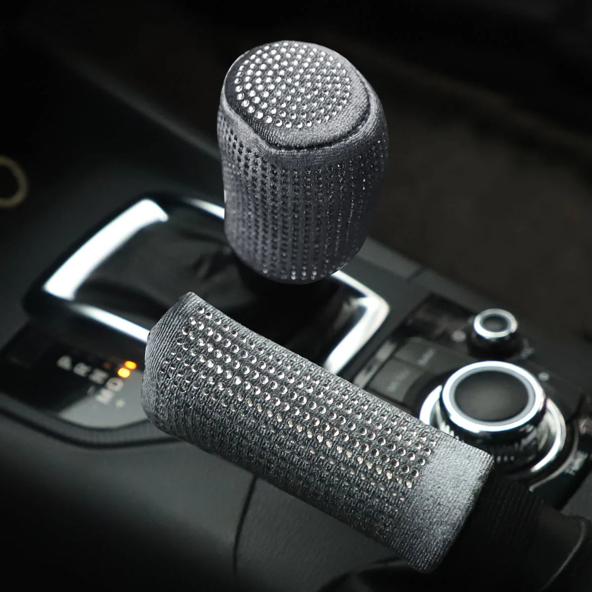 Gray plush bling diamond rhinestone handbrake and gear shift cover 2pc set installed on car center console with automatic gear selector in dark interior