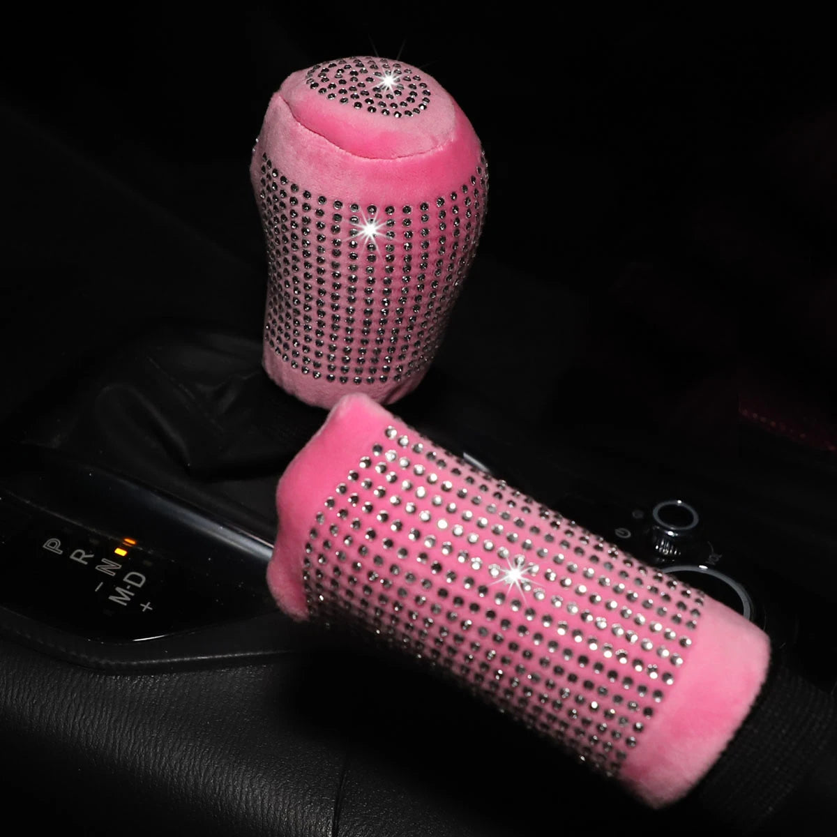 Pink plush bling diamond rhinestone handbrake and gear shift cover 2pc set sparkling in dark car interior showing gear selector and handbrake both covered