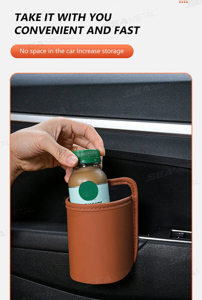 Hand placing drink bottle into brown small PU leather car door cup holder