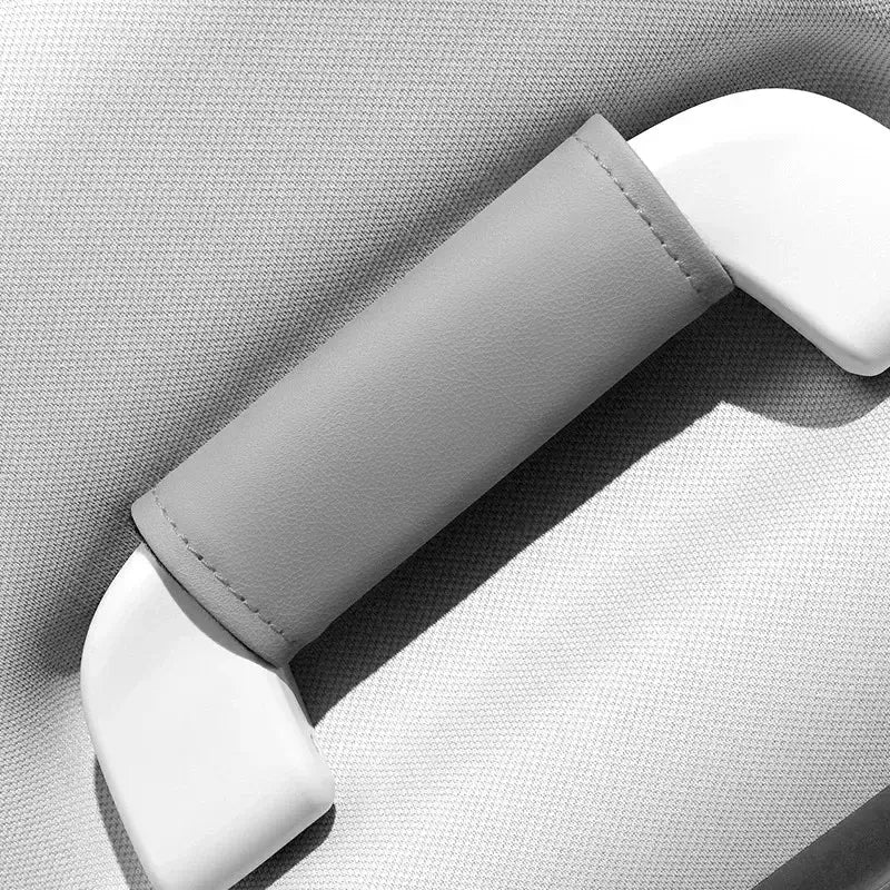 Single grey leather-look car roof handle cover installed on grab handle, close-up product shot