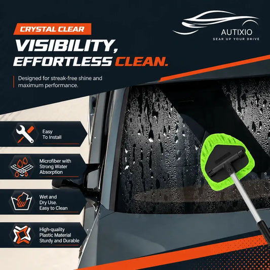 The green microfiber head from this car windshield cleaning kit wiping a water-covered, fogged windshield. It handles wet and dry passes alike and leaves not a single streak behind.