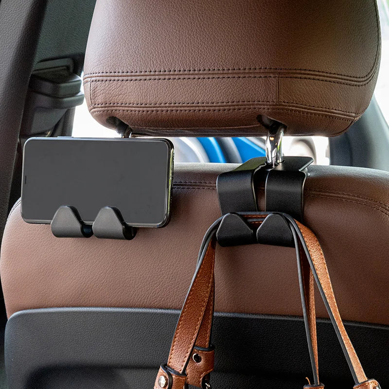 Car seat hooks organizer with phone holder and hanging purse bags in vehicle