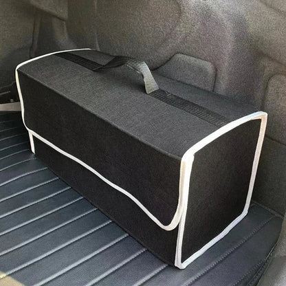 Black felt trunk organizer with white trim sitting in car cargo area angled side view