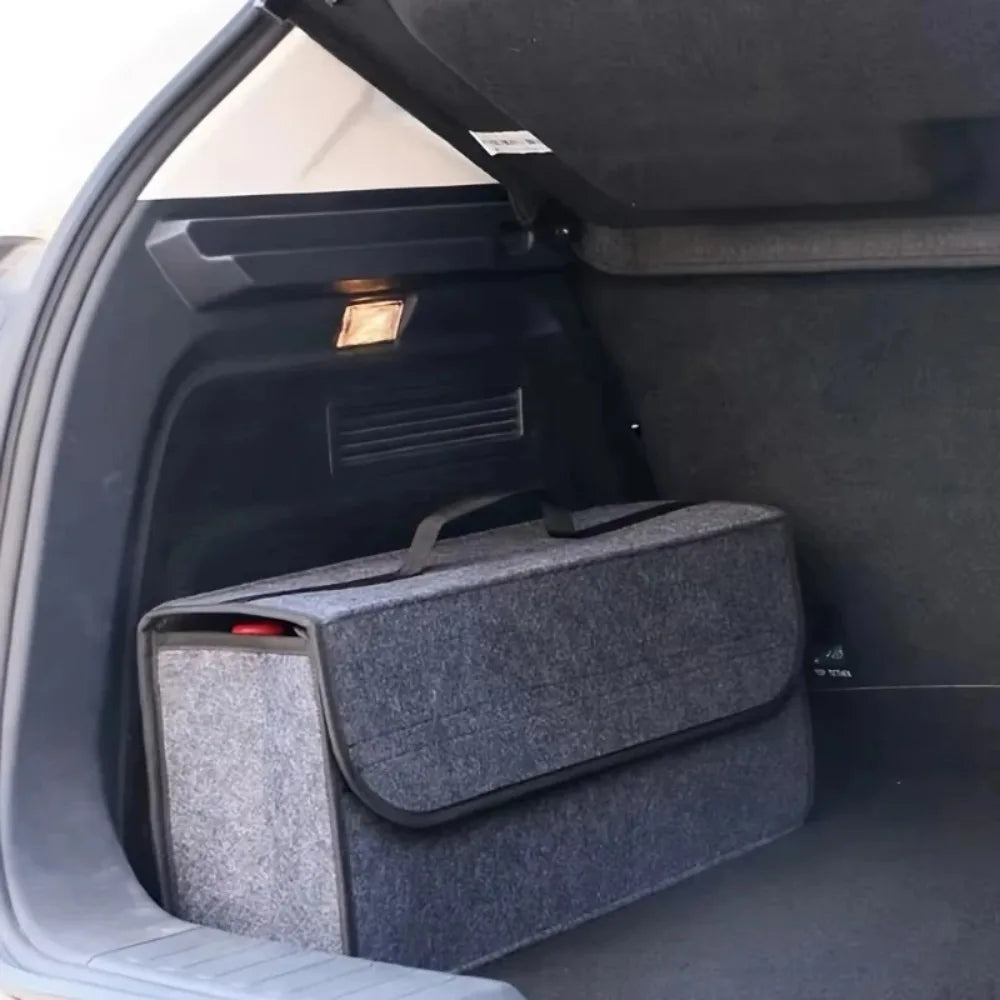 Dark gray felt trunk organizer with velcro flap closed placed inside open car cargo area