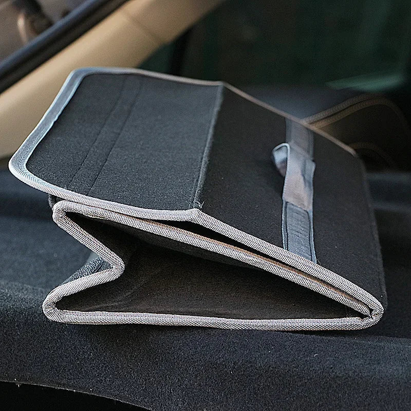 Felt trunk organizer folded flat on car floor showing space-saving foldable design