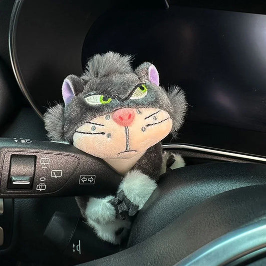 Grumpy cat plush toy clipped onto car turn signal lever as a quirky dashboard accessory