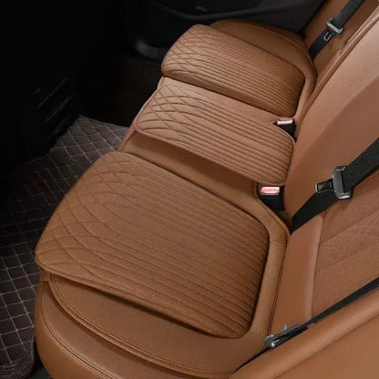 Orange leather car seat height cushion installed on rear seat showing thick padded profile and perforated surface