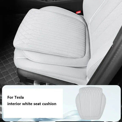 White leather car seat height cushion installed on Tesla white interior front seat with quilted diamond stitch design
