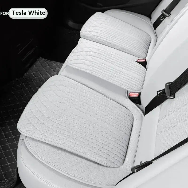 White leather car seat height cushion installed on Tesla white rear seat showing padded profile and anti-slip fit