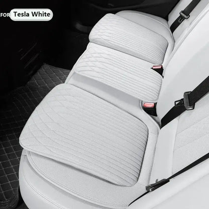 White leather car seat height cushion installed on Tesla white rear seat showing padded profile and anti-slip fit