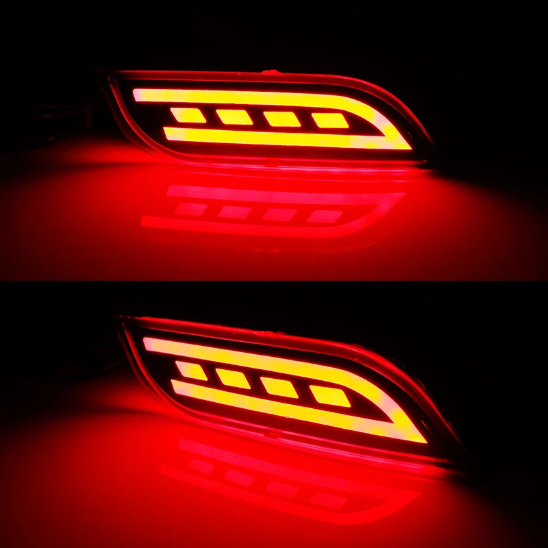 Close-up nighttime view of red LED bumper reflectors illuminated on vehicle body with high visibility