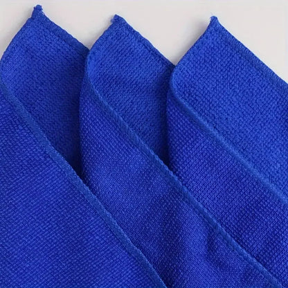 Close-up of three blue microfiber towels showing hemmed edge stitching