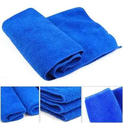 Folded blue microfiber car towels with close-up texture detail