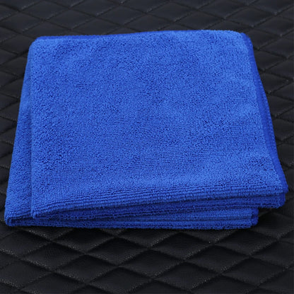 Thick microfiber towel in use on car hood for polishing and wax buffing
