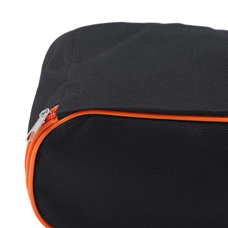 Metal zipper slider detail on orange zippered closure of storage pouch
