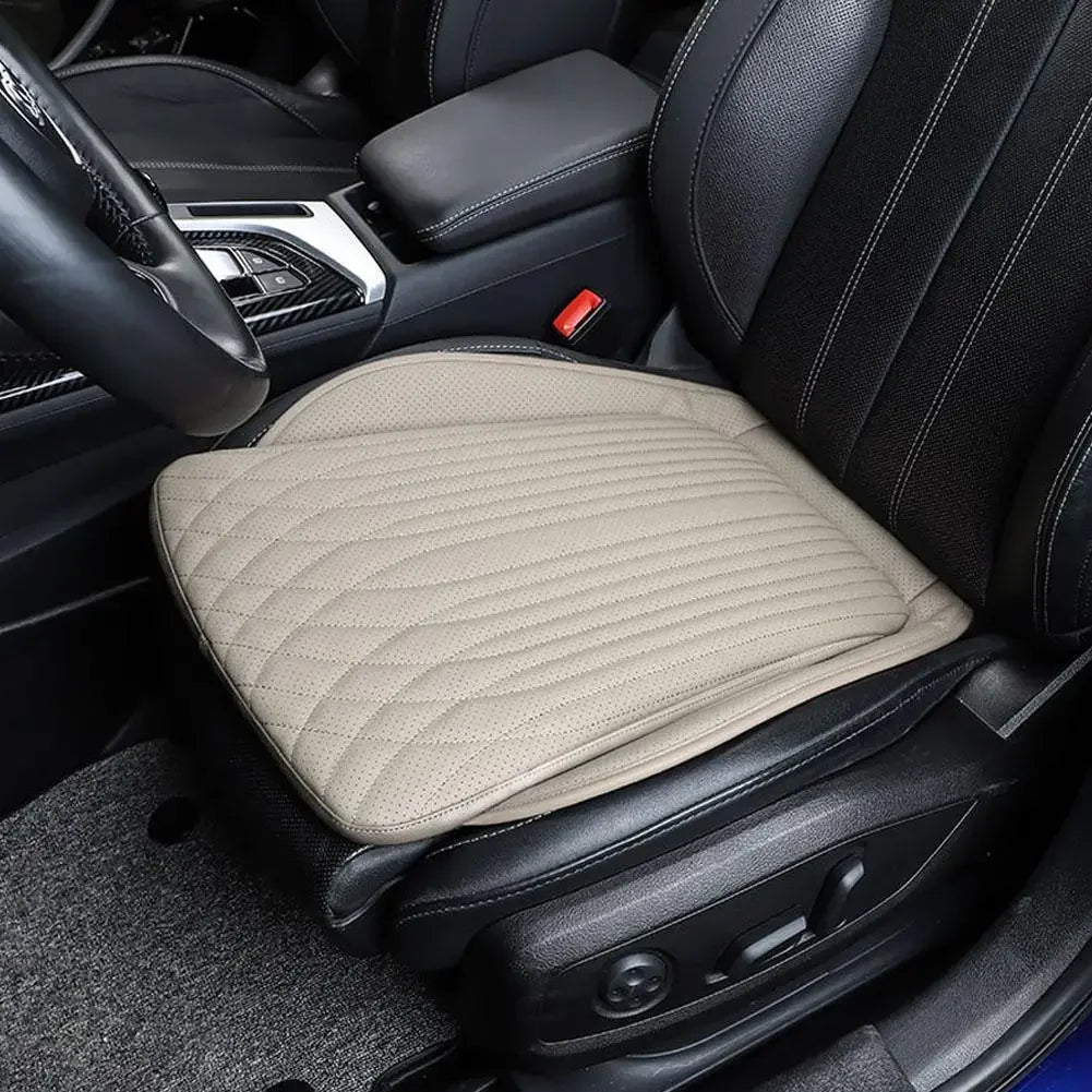 Beige PU leather car seat cushion on front driver seat, angled lifestyle view