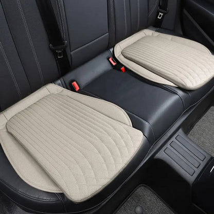 Beige PU leather seat cushions on rear car seat, pair installed side by side