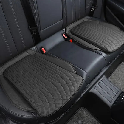 Black PU leather seat cushions on rear car seat, pair installed side by side