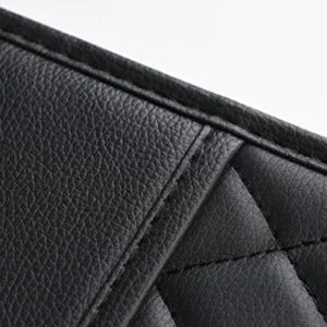 Close-up of reinforced stitching seam on black PU leather car seat back organizer