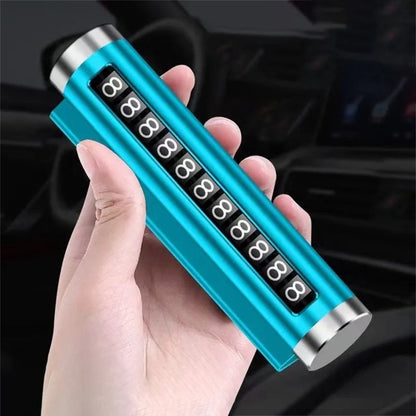 Blue metal rotating car parking number plate held in hand at angle with car interior background