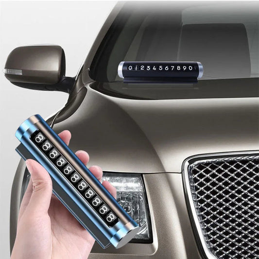 Rotating car parking phone number plate in blue held in hand with plate mounted on car windshield in background