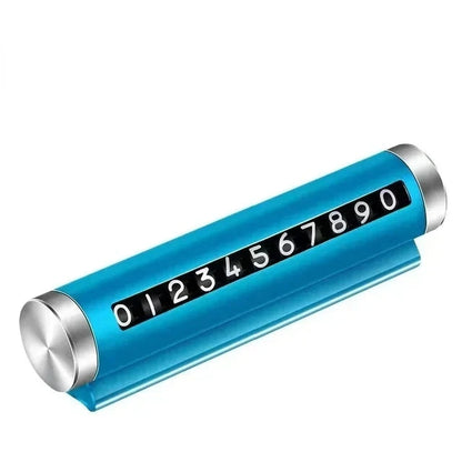 Blue metal rotating car parking number plate on white background showing full 0 to 9 digit roller and dashboard stand