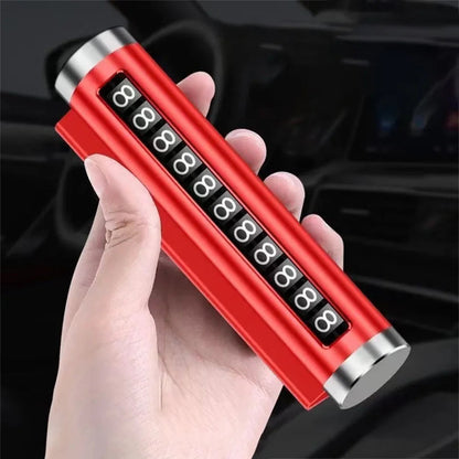 Red metal rotating car parking number plate held in hand at angle with car interior background