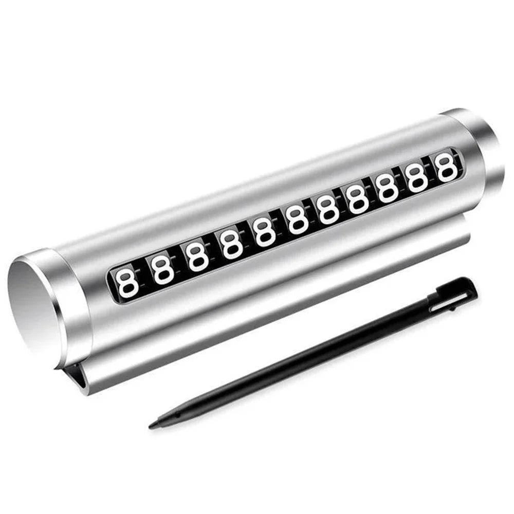 Silver metal rotating parking number plate with stylus pen on white background showing full product