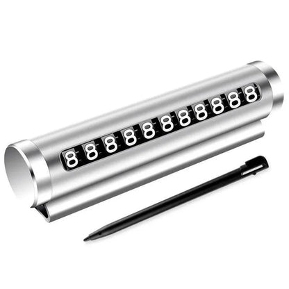 Silver metal rotating parking number plate with stylus pen on white background showing full product