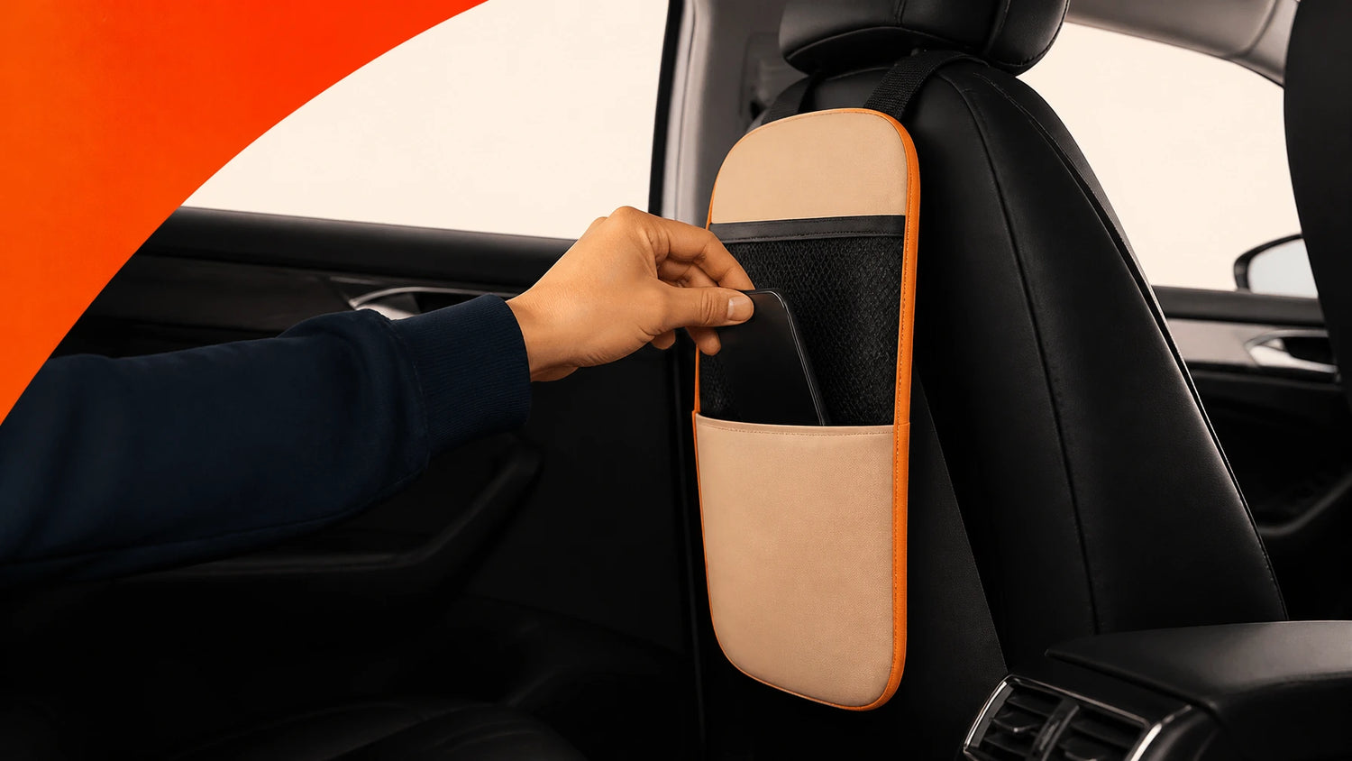 Hand reaching for a car headrest organizer in a vehicle.