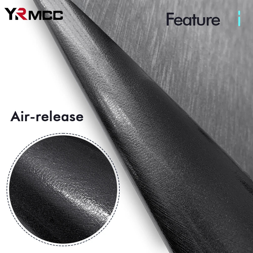 Close-up of brushed vinyl wrap film edge showing air-release channel backing for bubble-free installation