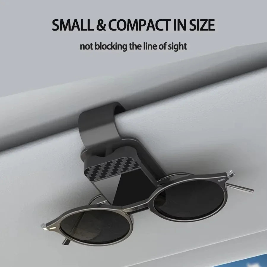 Compact black sun visor glasses clip holding sunglasses on car visor