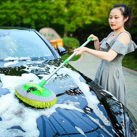 Woman washing dark car roof with telescopic chenille mop at full extension