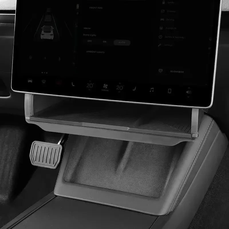 Empty Tesla Model Y center console organizer tray showing storage compartment design