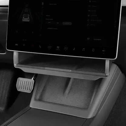 Empty Tesla Model Y center console organizer tray showing storage compartment design