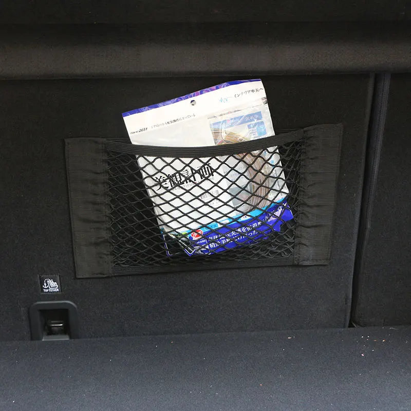 Trunk cargo net mounted on car boot wall storing documents and packages