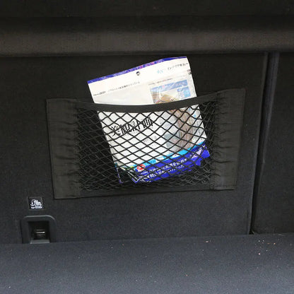 Trunk cargo net mounted on car boot wall storing documents and packages