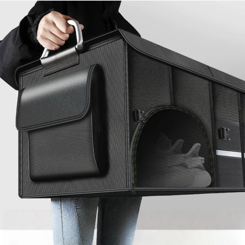 Person carrying foldable trunk organizer by metal handle