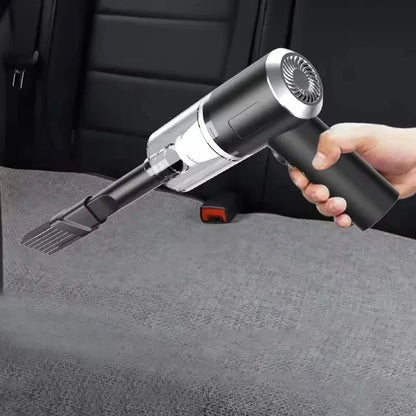 Handheld USB vacuum cleaner held in hand on car seat interior